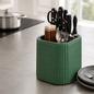 Green knife block with cutlery on a kitchen counter