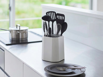 Kitchen utensil holder with black utensils on a kitchen counter