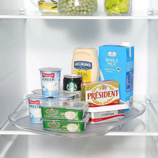 Assorted food items including yogurt, cream cheese, and milk cartons on a refrigerator shelf.