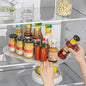 Person using a refrigerator shelf organizer with various condiments in a kitchen.
